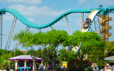 Atlantis ride at SeaWorld San Antonio with visitors on a steep descent.