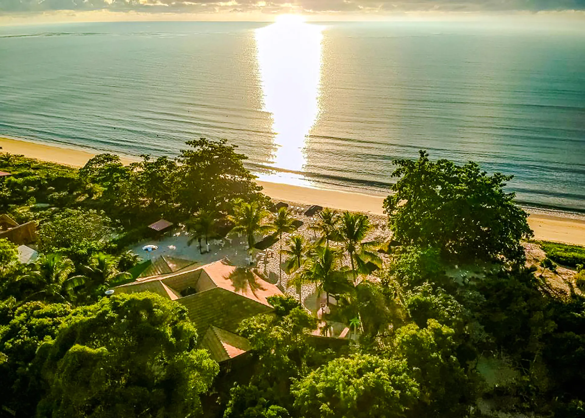 Aerial view of Coroa Vermelha beach with lush greenery and ocean in Porto Seguro, Brazil.