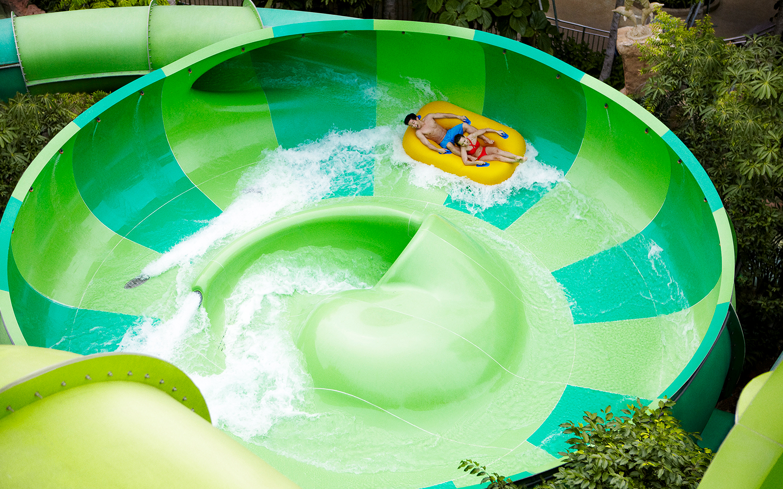 Guests riding inflatable raft on Whirlpool Washout at Adventure Cove Waterpark.