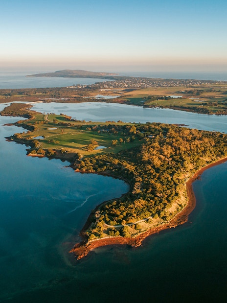 Aerial view of Churchill Island surrounded by water and lush greenery.