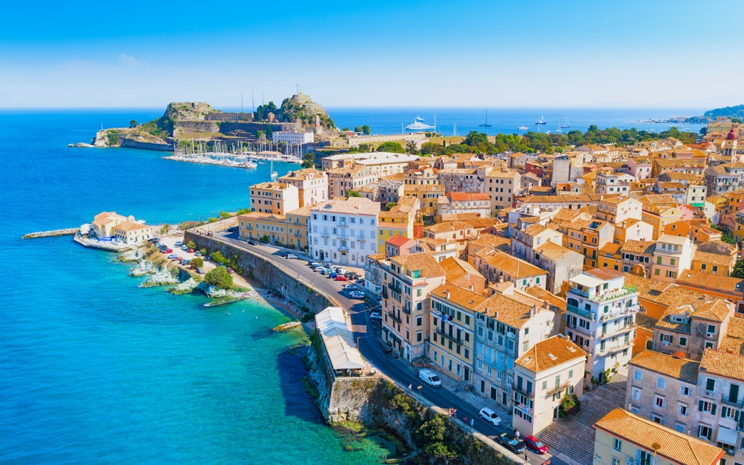 Aerial view of Corfu Old Town with coastal fortifications and blue sea, Corfu, Greece.