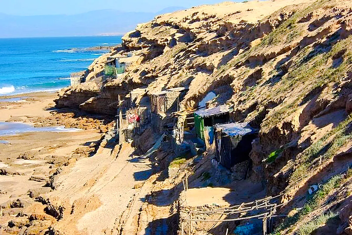Cliffside huts along the rocky coast during Massa & Tiznit Jeep Safari, Agadir.
