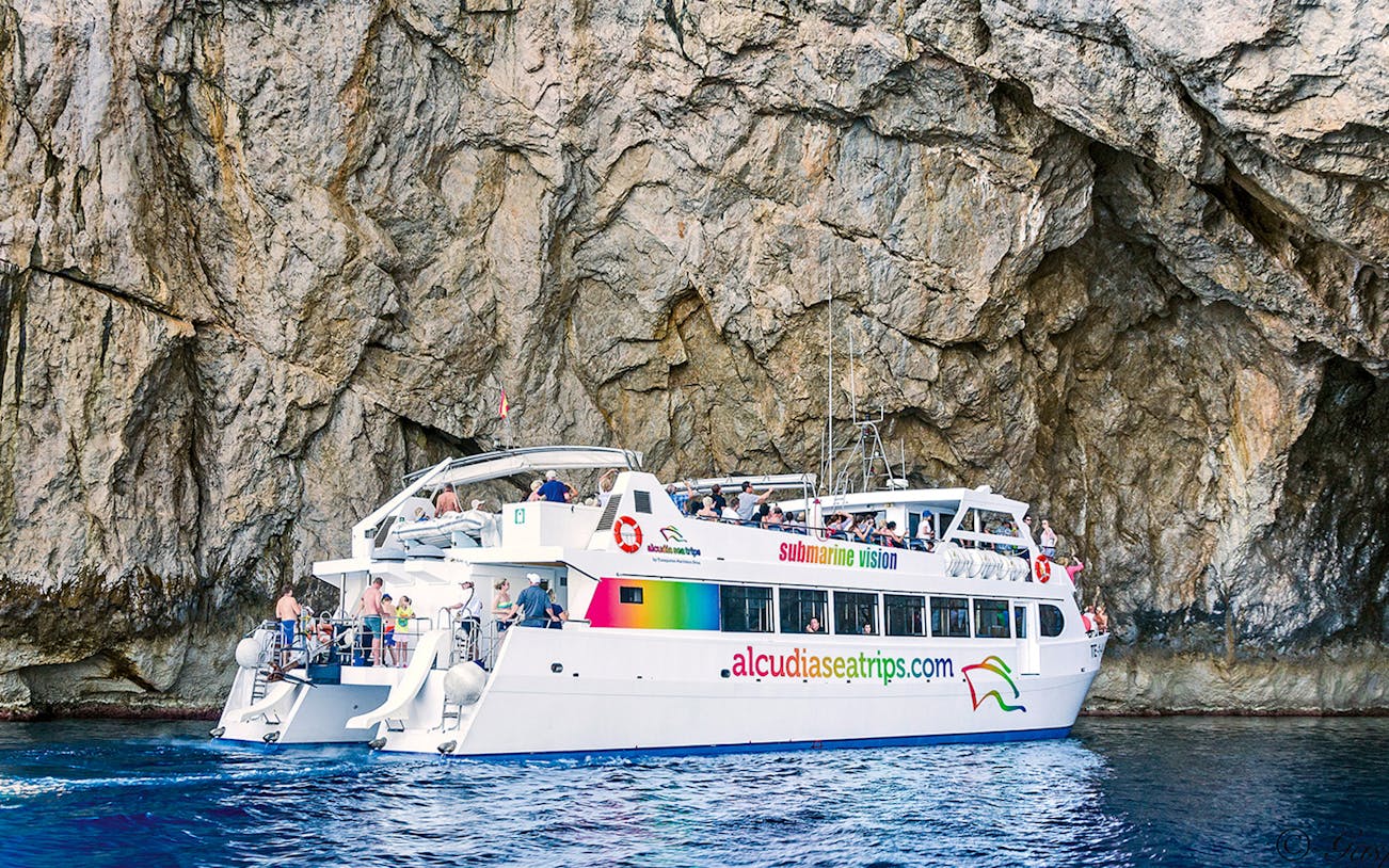 Boat tour near rocky cliffs at Cap Formentor, Mallorca.