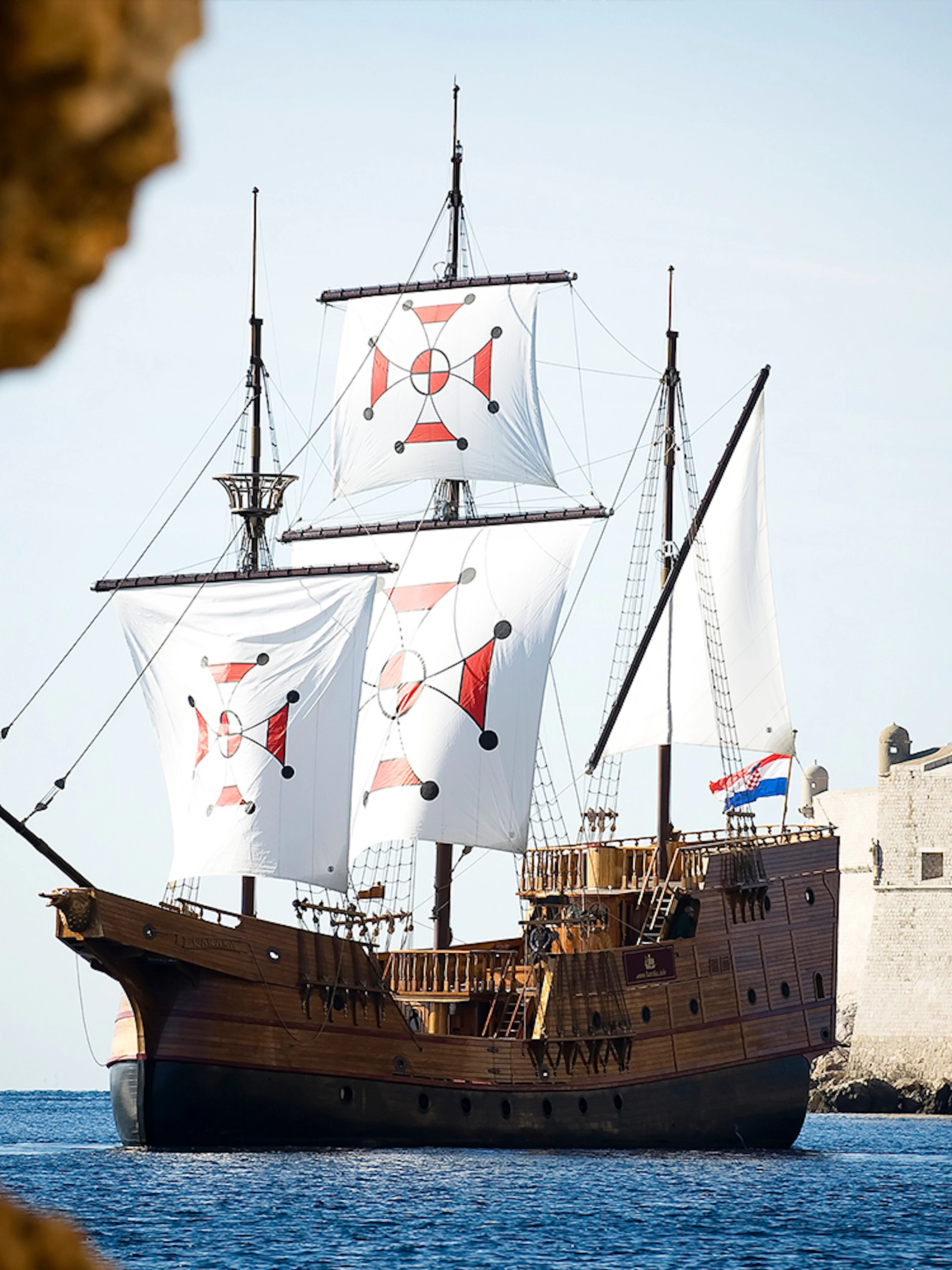 Historic ship sailing near Dubrovnik city walls on Panoramic Cruise and Walking Tour.
