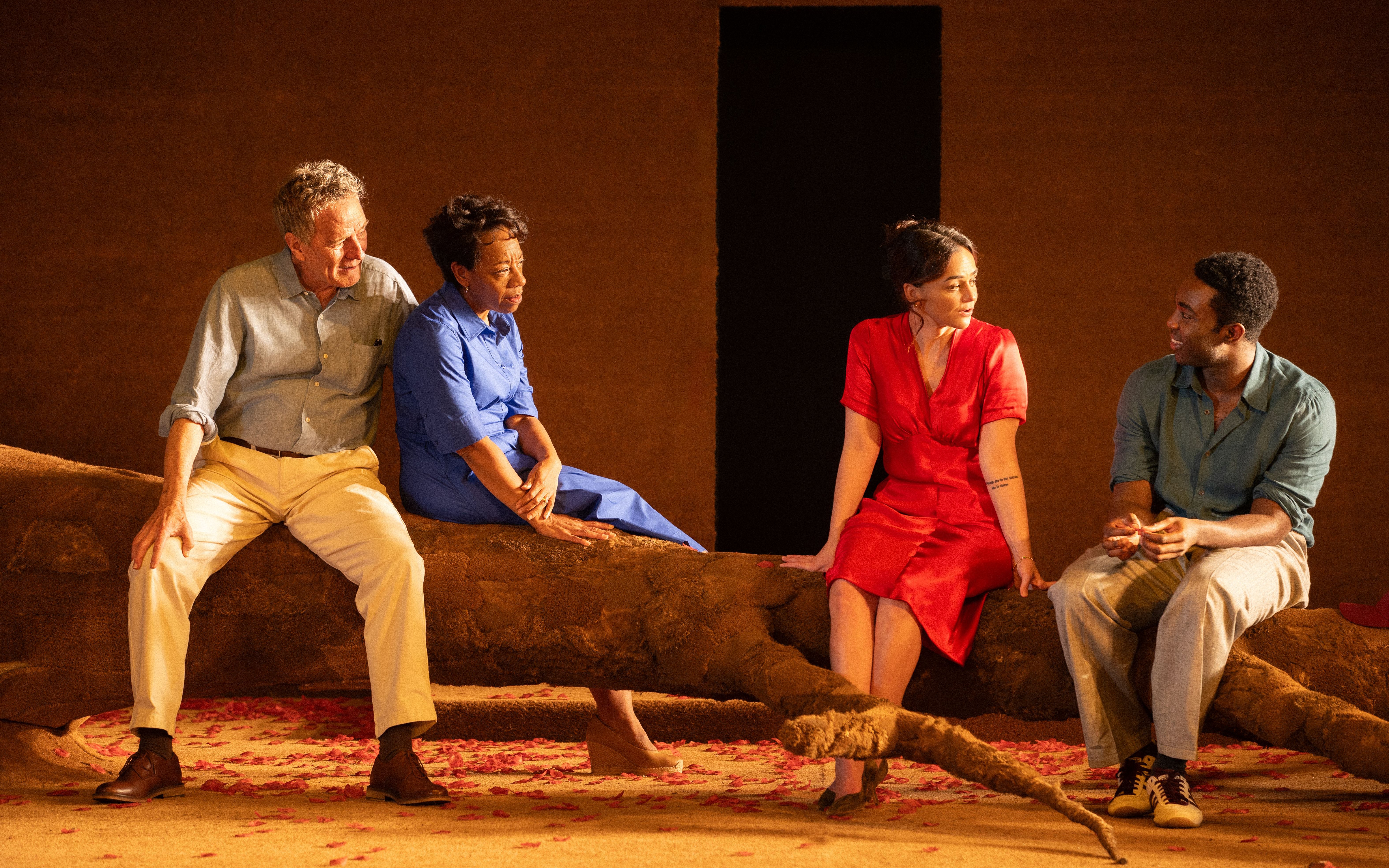 Actors sitting on stage during "All My Sons" West End show performance.