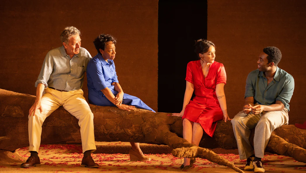 Actors sitting on stage during "All My Sons" West End show performance.