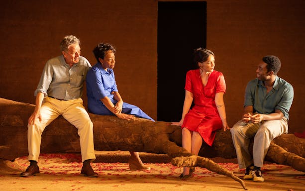 Actors sitting on stage during "All My Sons" West End show performance.
