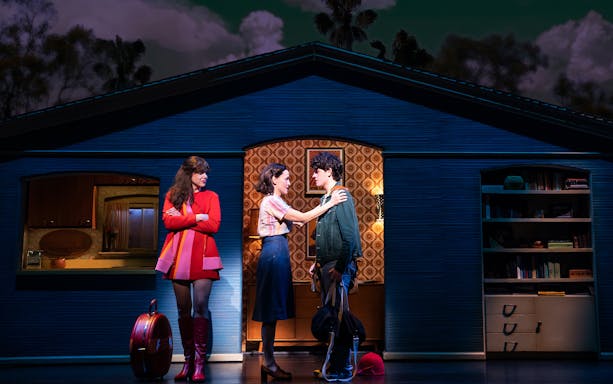 Stage scene from "Almost Famous" musical with three characters interacting.