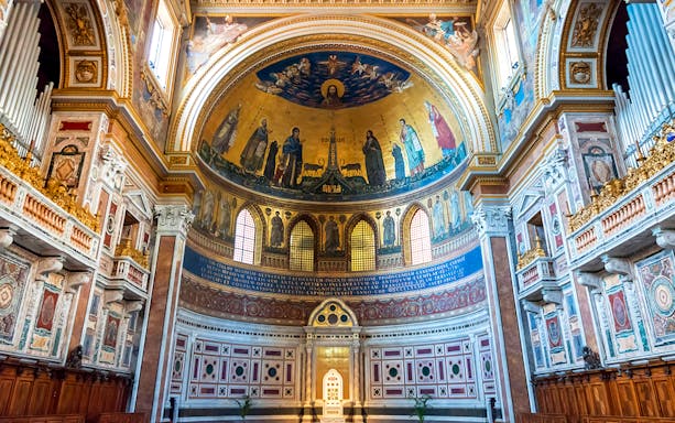Interior of the Basilica of Saint John in Lateran, showcasing ornate frescoes and architectural details.