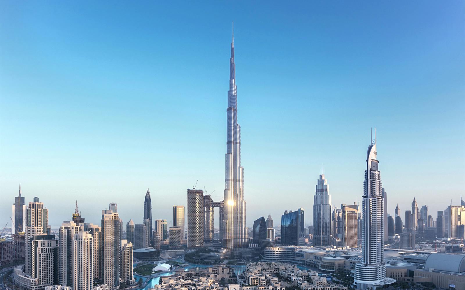 Burj Khalifa towering over Dubai skyline with surrounding skyscrapers.