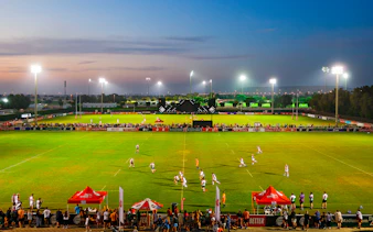 Rugby match at Emirates Dubai 7s stadium during evening, Dubai, UAE.