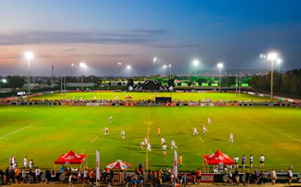 Rugby match at Emirates Dubai 7s stadium during evening, Dubai, UAE.