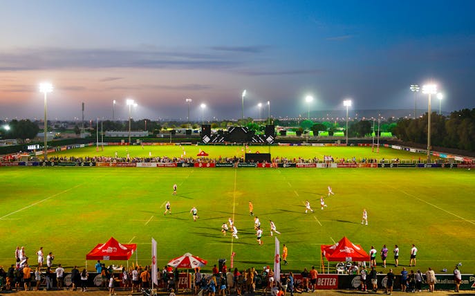 Rugby match at Emirates Dubai 7s stadium during evening, Dubai, UAE.