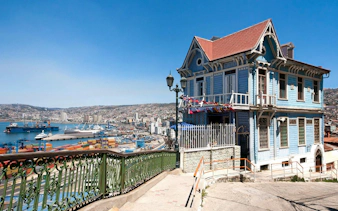 Colorful historic house overlooking Valparaíso port and cityscape in Chile.
