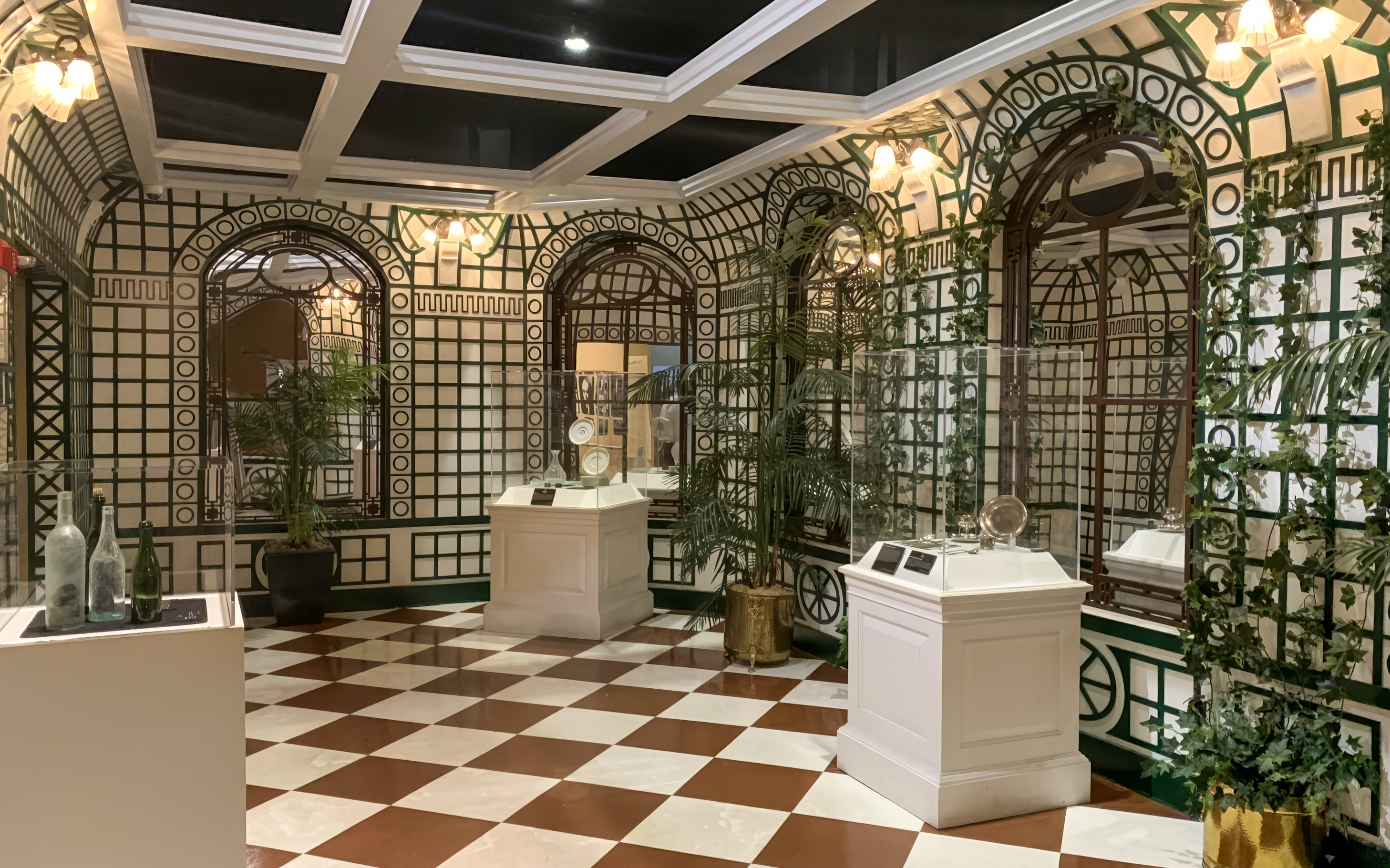 Artifacts displayed in a room with checkered floor at Titanic: The Artifact Exhibition.