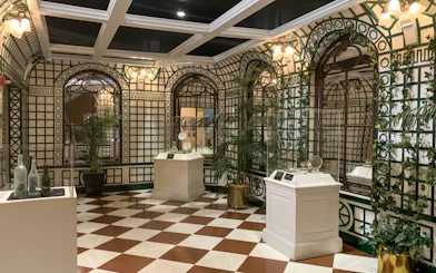 Artifacts displayed in a room with checkered floor at Titanic: The Artifact Exhibition.