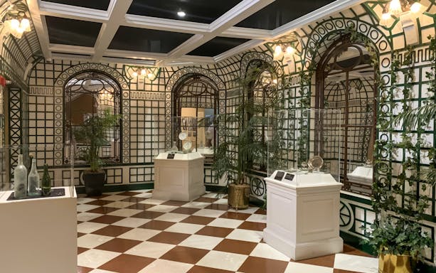 Artifacts displayed in a room with checkered floor at Titanic: The Artifact Exhibition.