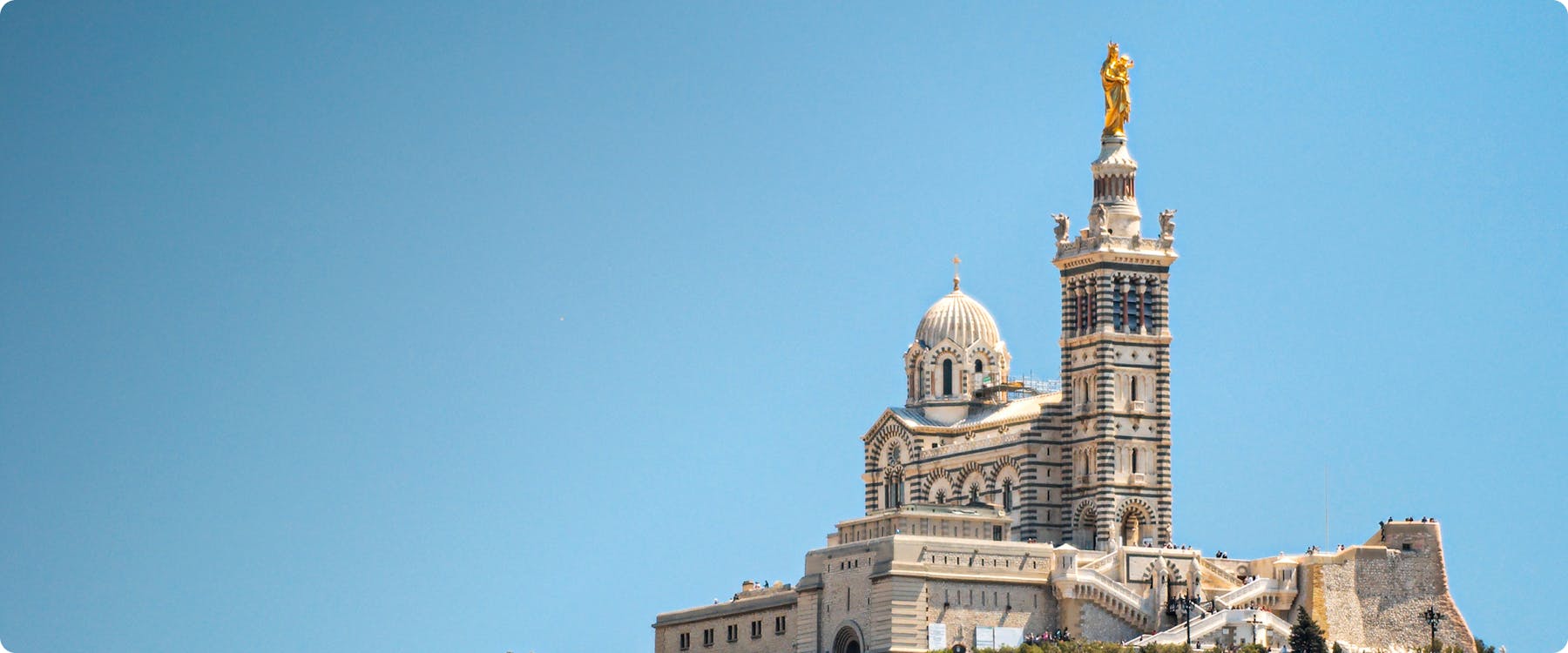 Notre-Dame de la Garde basilica in Marseille against a clear blue sky.