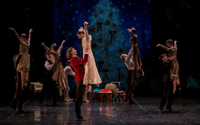 Dancers performing The Nutcracker Ballet at Hybernia Theater, Prague with a festive backdrop.
