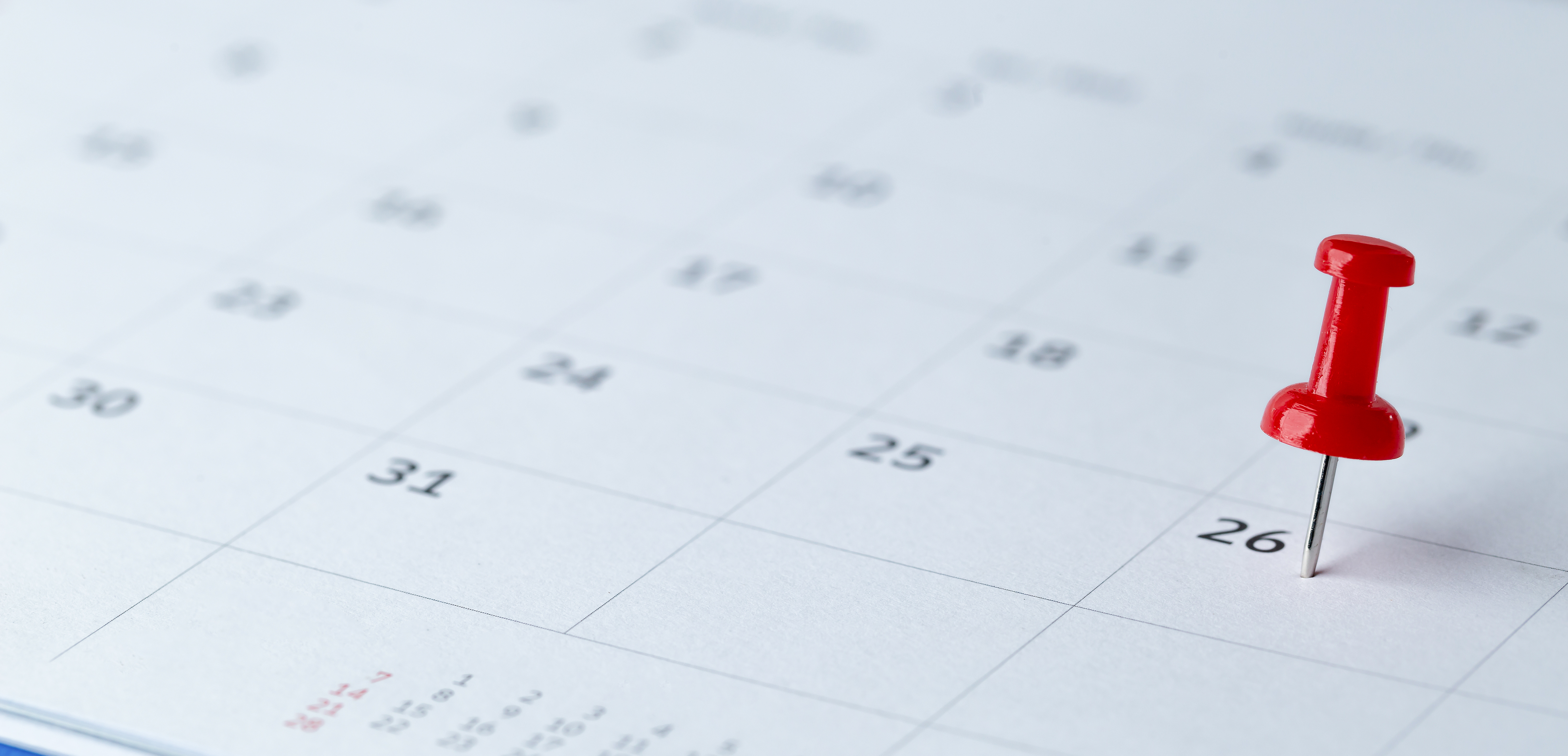 Calendar page with red pushpin marking the 26th.