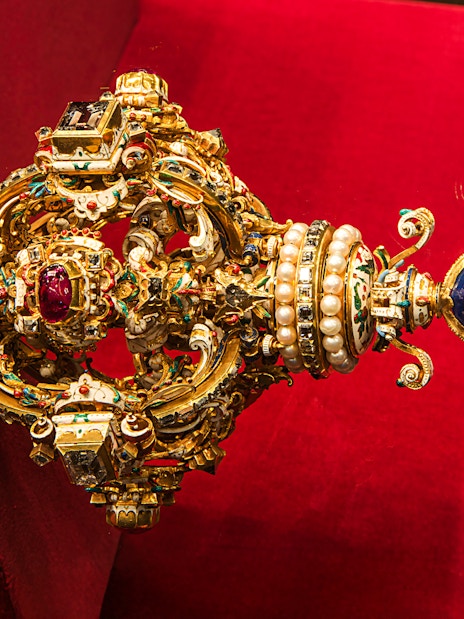 Ornate jeweled scepter with pearls and gemstones at Imperial Treasury Vienna.