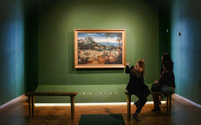 Visitors viewing a painting at Lobkowicz Palace Museum, Prague.