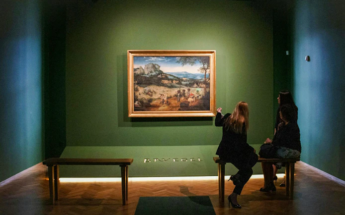 Visitors viewing a painting at Lobkowicz Palace Museum, Prague.