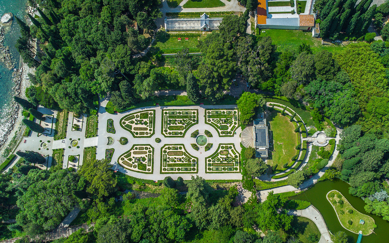 Aerial view of Miramare Castle gardens in Trieste, Italy, showcasing intricate landscaping and pathways.