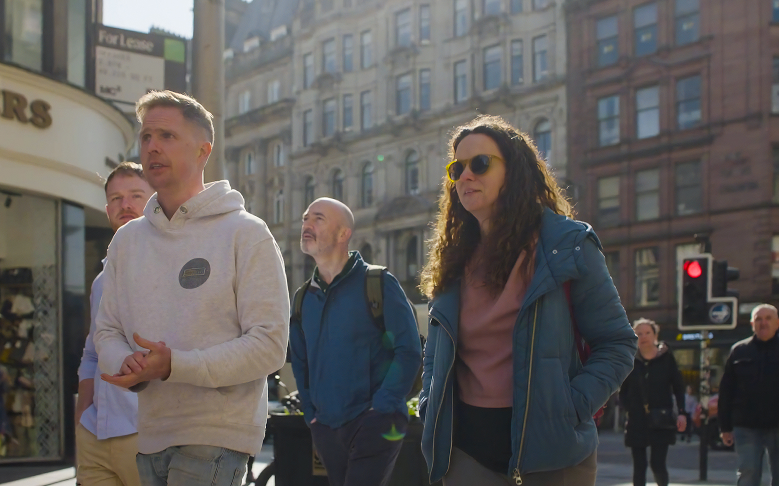 Group exploring Glasgow city streets on a walking tour.