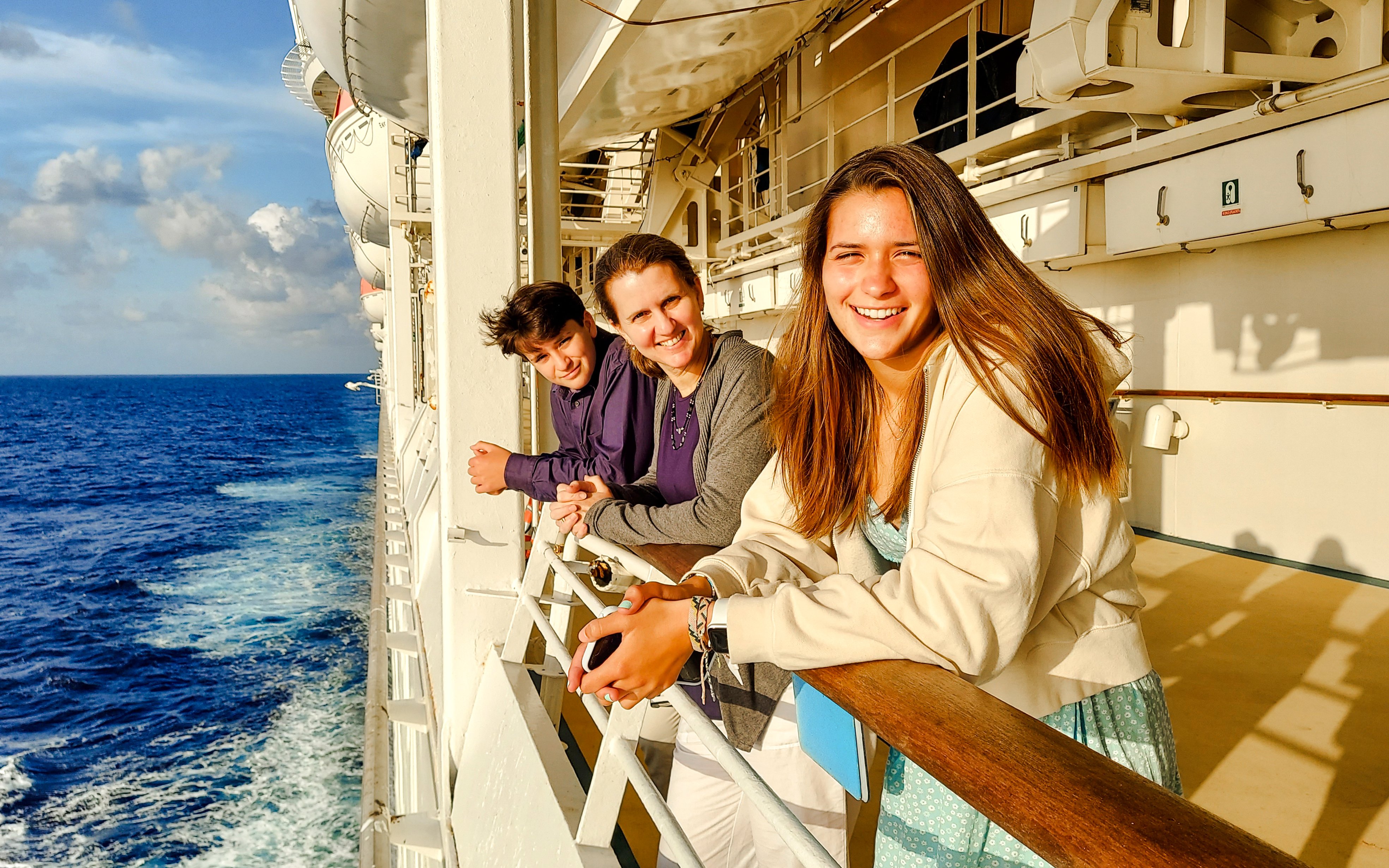 Family enjoying ocean view from cruise ship deck.
