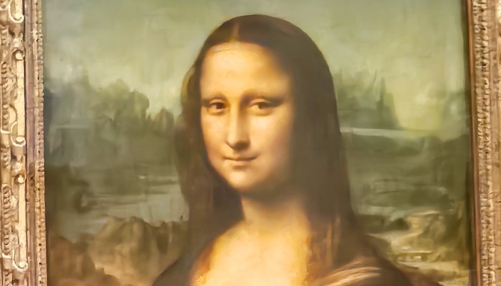 Mona Lisa painting close-up, showcasing her enigmatic smile and eyes at the Louvre Museum, Paris.