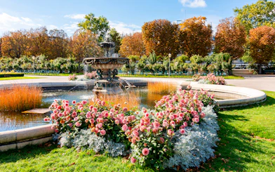 Fountain and flower garden in Vienna near Sisi Museum on a sunny day.