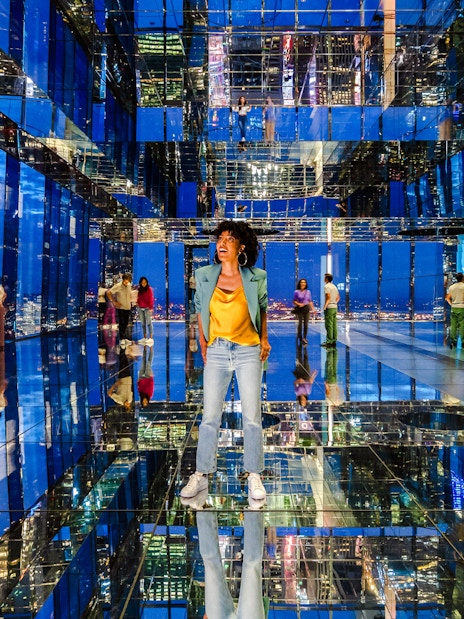 Guests exploring mirrored observatory at Summit One Vanderbilt at night.