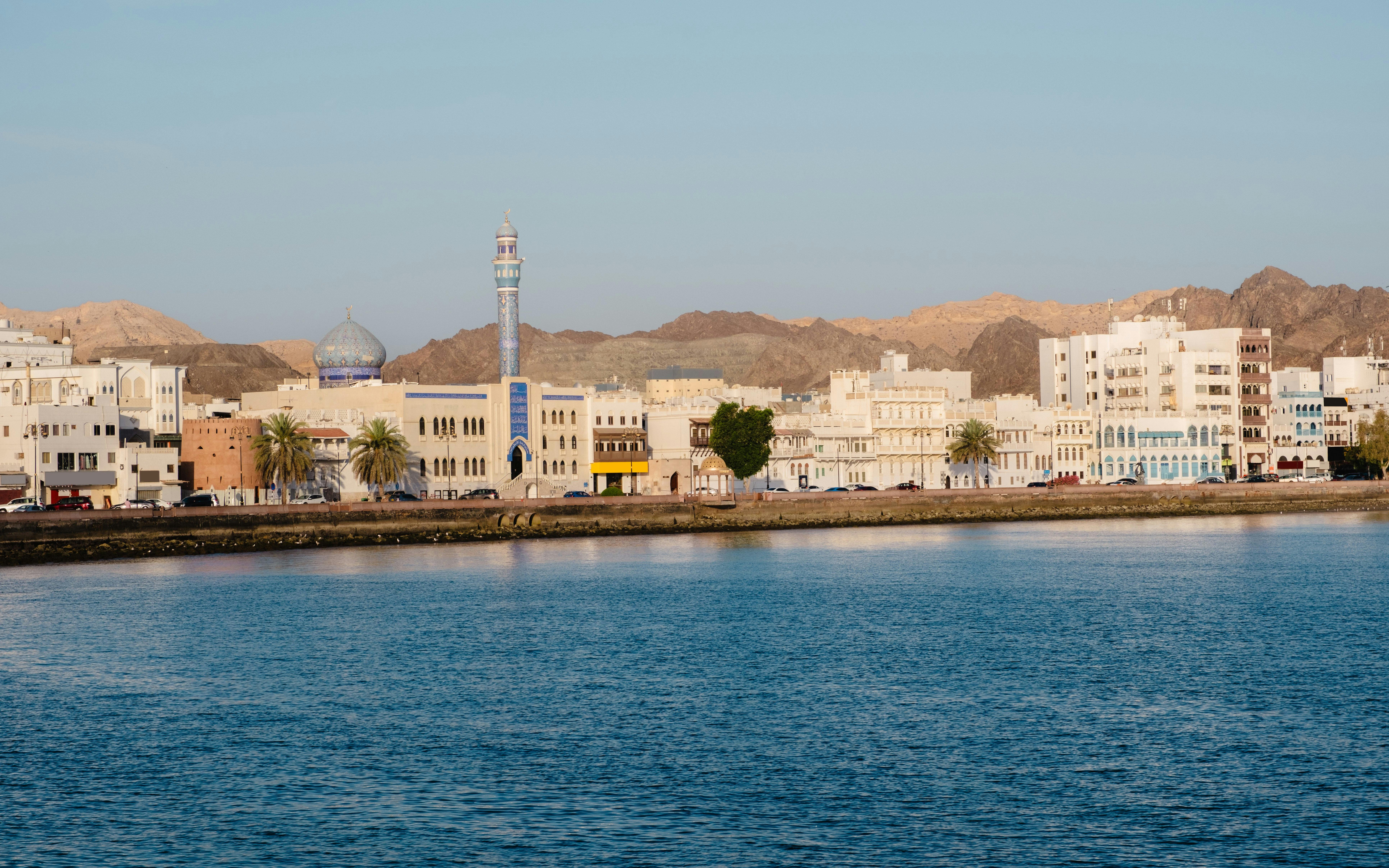 Muttrah Corniche with mosque and Hajar mountains in the background, Oman.