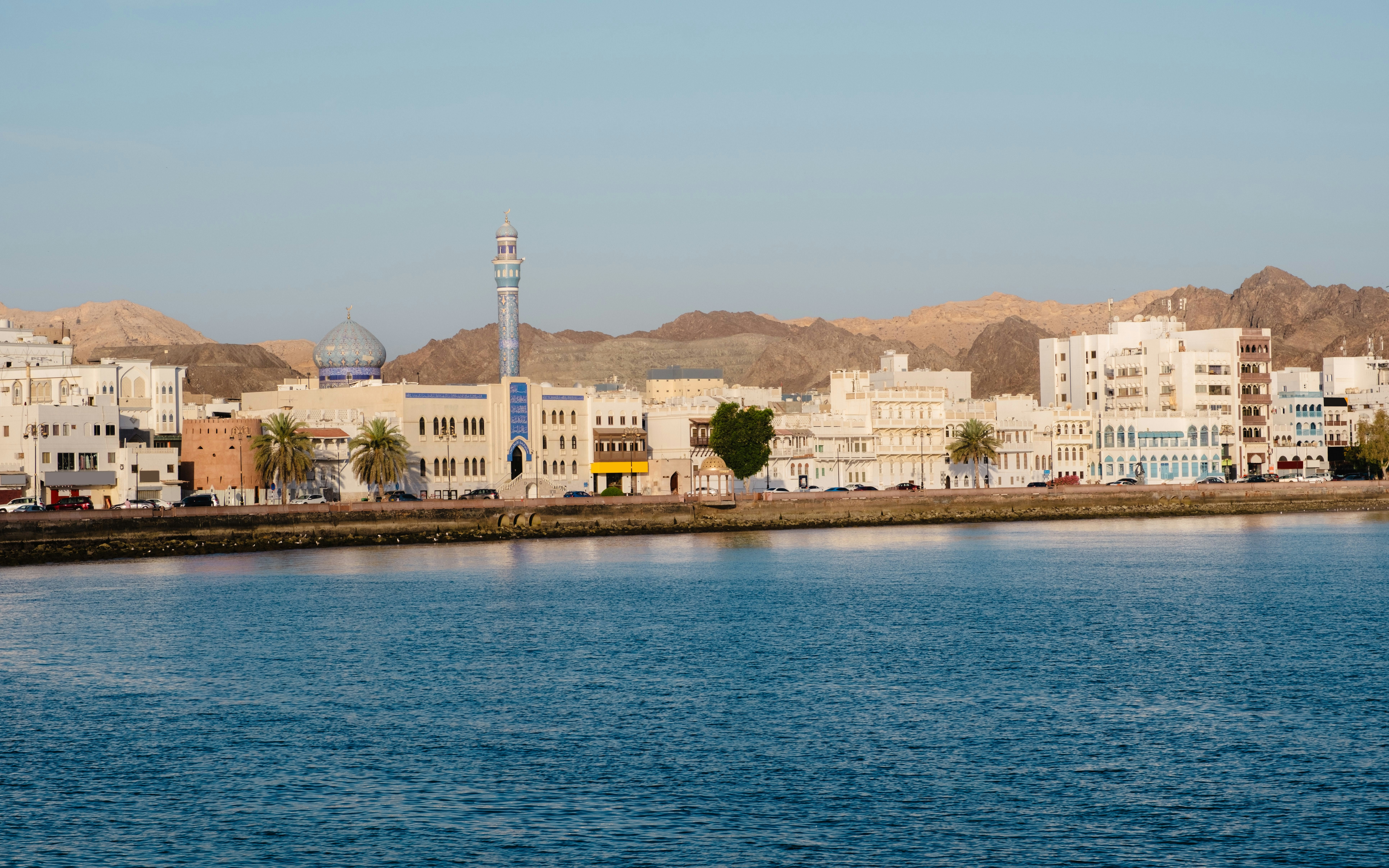 Muttrah Corniche with mosque and Hajar mountains in the background, Oman.