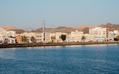 Muttrah Corniche with mosque and Hajar mountains in the background, Oman.