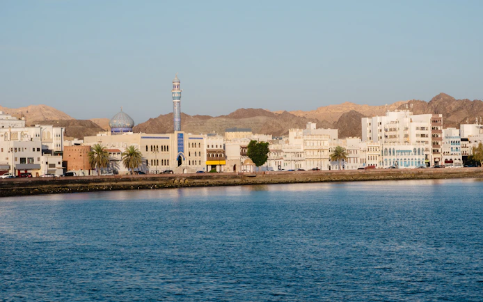 Muttrah Corniche with mosque and Hajar mountains in the background, Oman.
