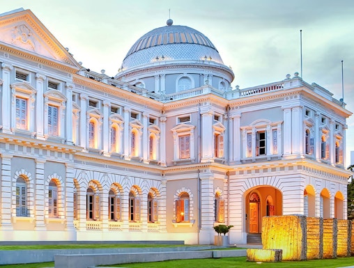National Museum of Singapore exterior with illuminated facade at dusk.