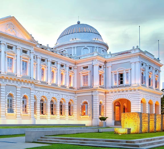 National Museum of Singapore exterior with illuminated facade at dusk.