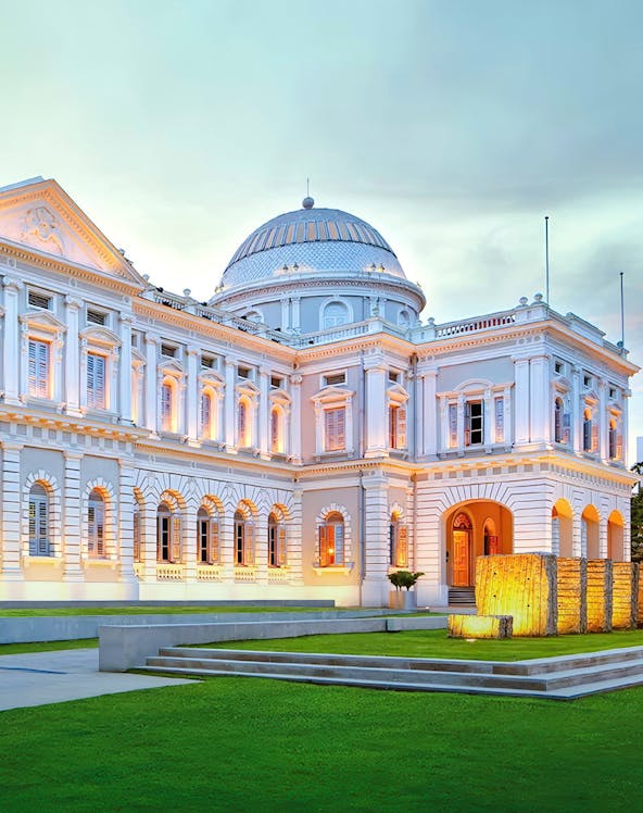 National Museum of Singapore exterior with illuminated facade at dusk.