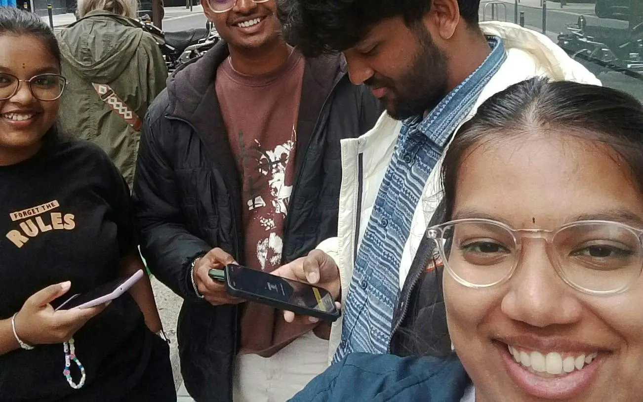 Group of friends using phones for Dublin Secret Society Mystery game.
