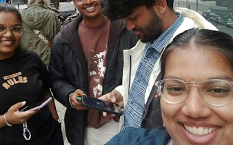 Group of friends using phones for Dublin Secret Society Mystery game.