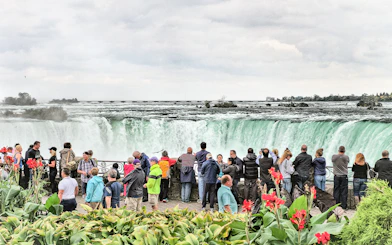 Tourists viewing Niagara Falls from a lookout point in Canada.