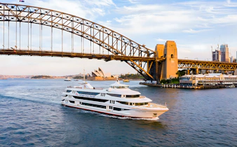 Cruise ship on Sydney Harbour near Sydney Opera House and Harbour Bridge.