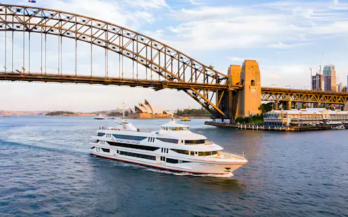 Cruise ship on Sydney Harbour near Sydney Opera House and Harbour Bridge.