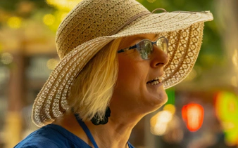 Local guide in a sun hat leading a Prague small-group walking tour.