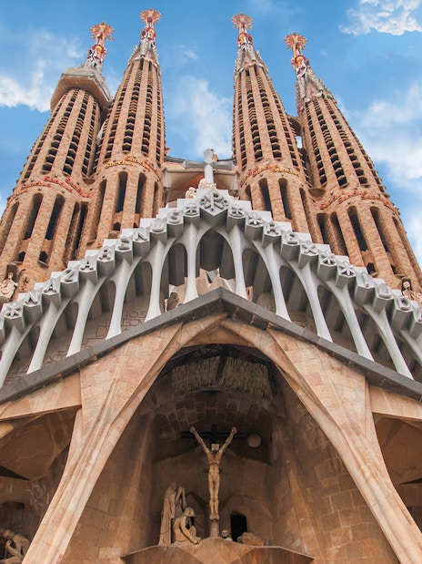 Facade detail of Sagrada Familia, Barcelona, showing intricate stone carvings and spires.