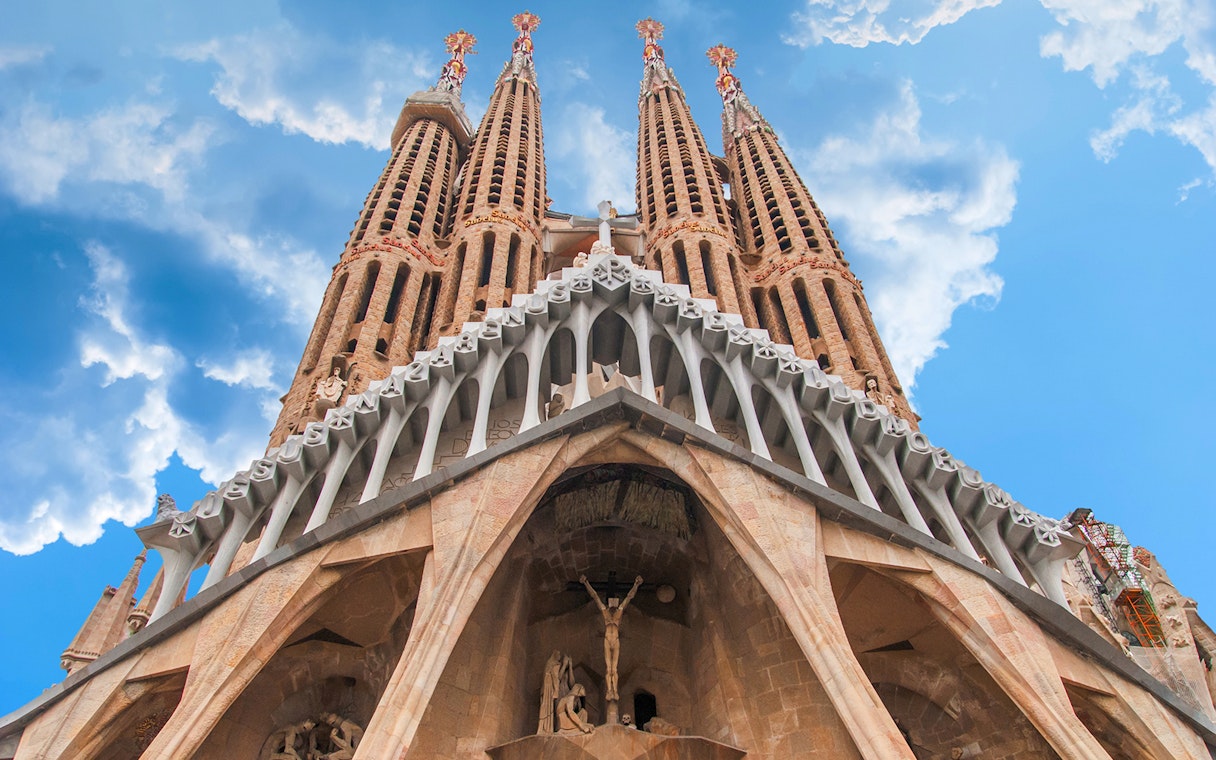 Facade detail of Sagrada Familia, Barcelona, showing intricate stone carvings and spires.