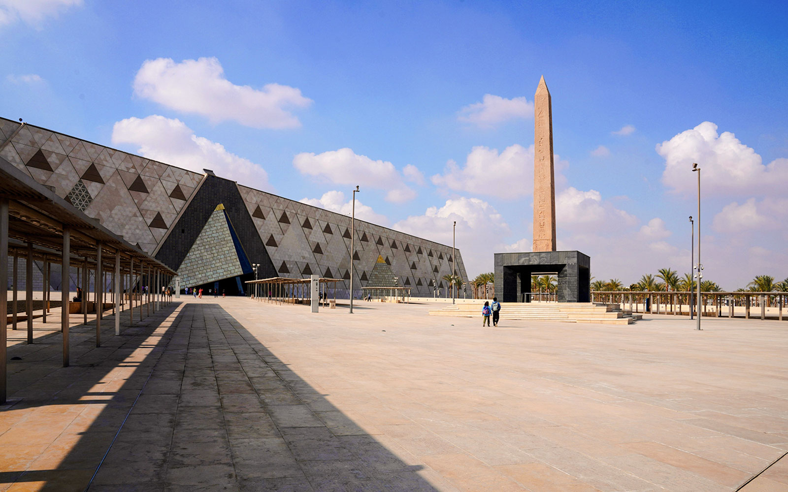 Grand Egyptian Museum entrance with obelisk and modern architecture in Giza, Egypt.
