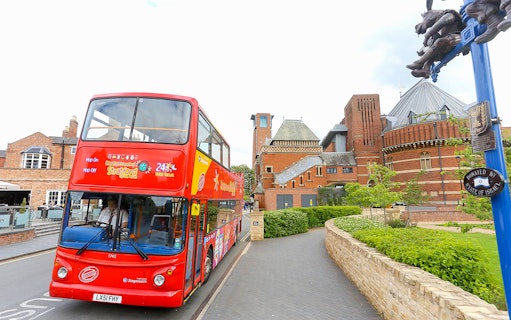 Red double-decker bus on City Sightseeing tour near Royal Shakespeare Theatre, Stratford-upon-Avon.